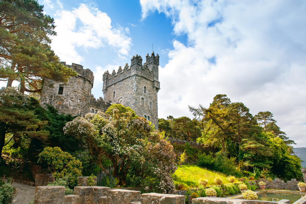 beautiful castellated mansion peeking out over a forest in Donegal Ireland 