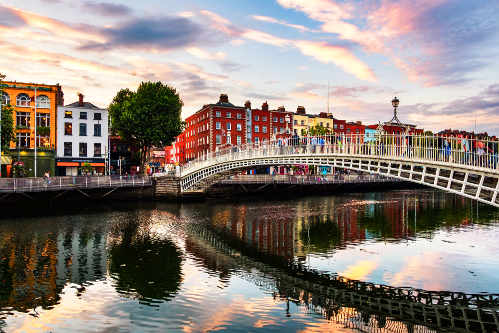 A view over halfpenny Bridge in Dublin at sunset.