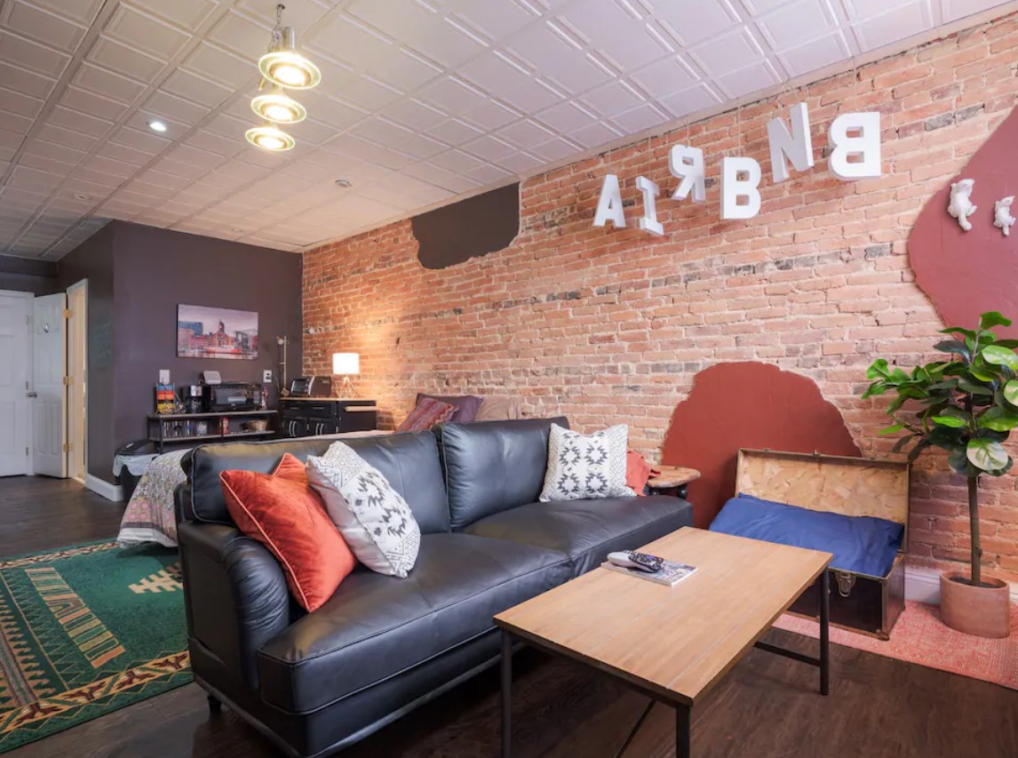 Sitting area in apartment with exposed brick wall