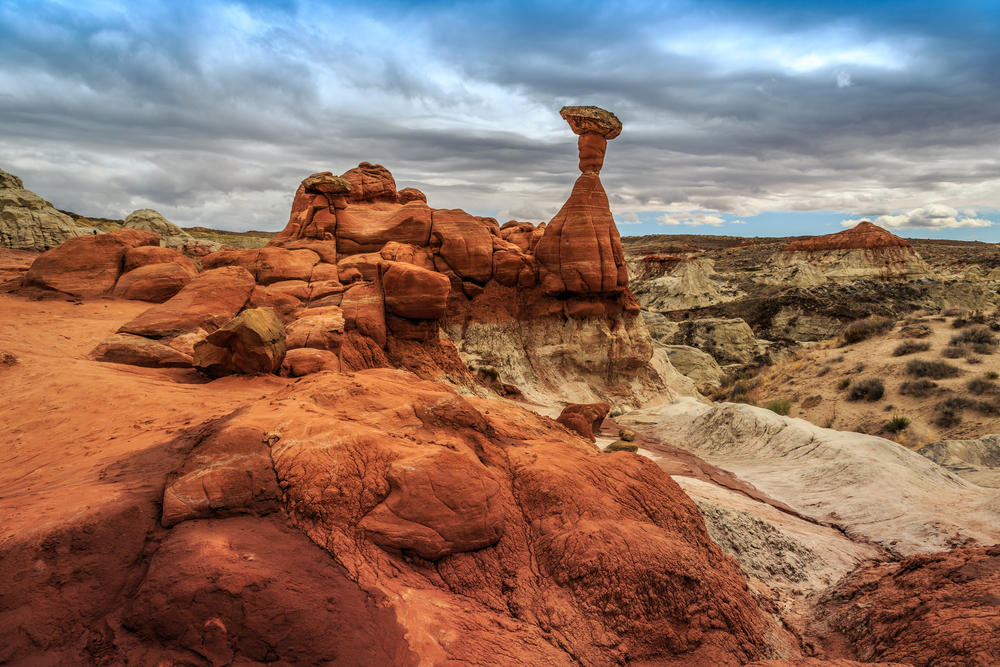 The toadstool shaped rocks at Grand Staircase Escalante National Monument overlooking a vista on a cloudy day.