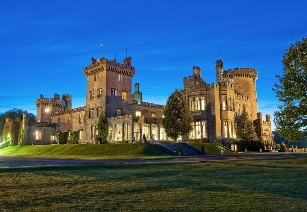 Castle hotel in Ireland. There are turrets and a large lawn in front.  