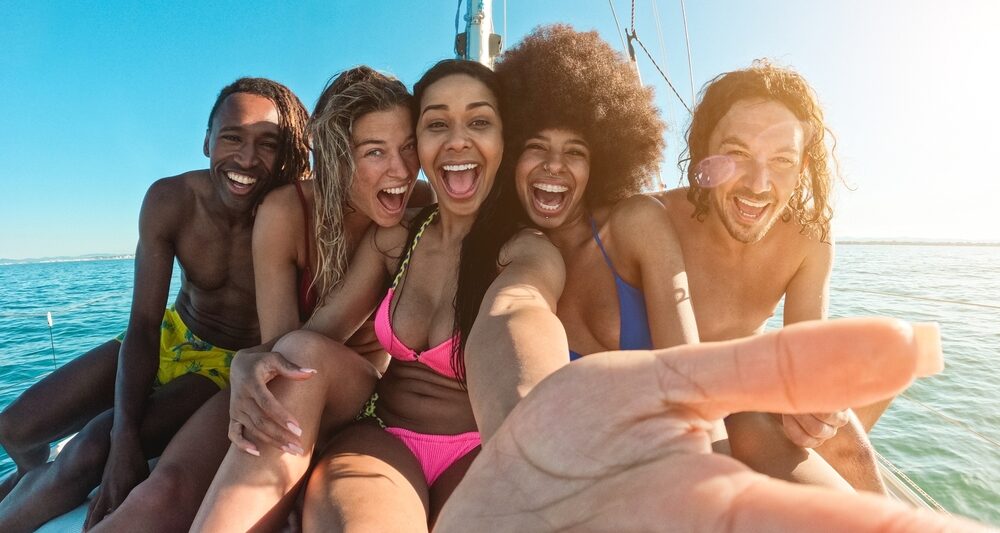 Group of friends on a sailboat on one of the 30th birthday destinations to celebrate.