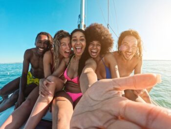 Group of friends on a sailboat on one of the 30th birthday destinations to celebrate.