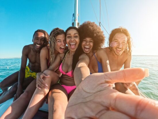 Group of friends on a sailboat on one of the 30th birthday destinations to celebrate.