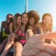 Group of friends on a sailboat on one of the 30th birthday destinations to celebrate.