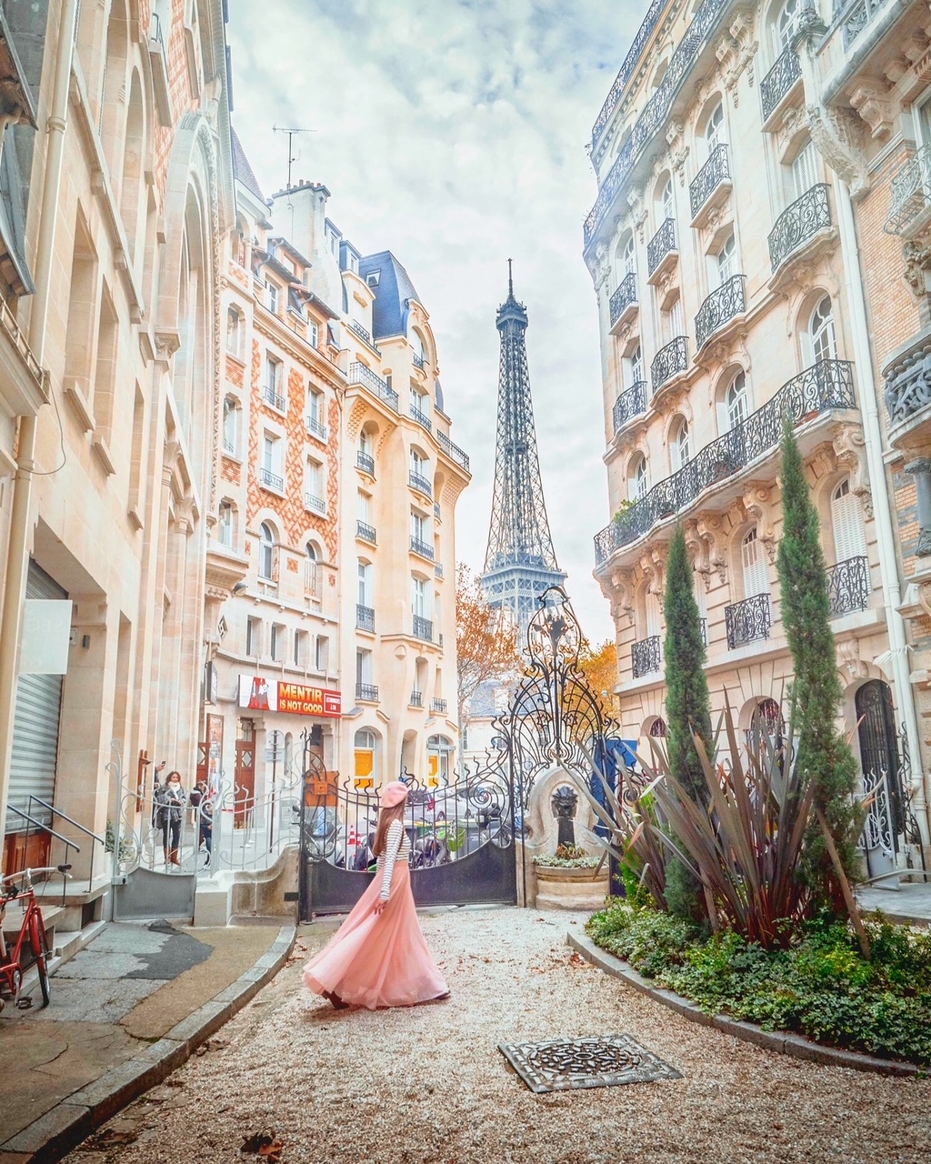 Me on a side street with a view of the Eiffel Tower in the background. 