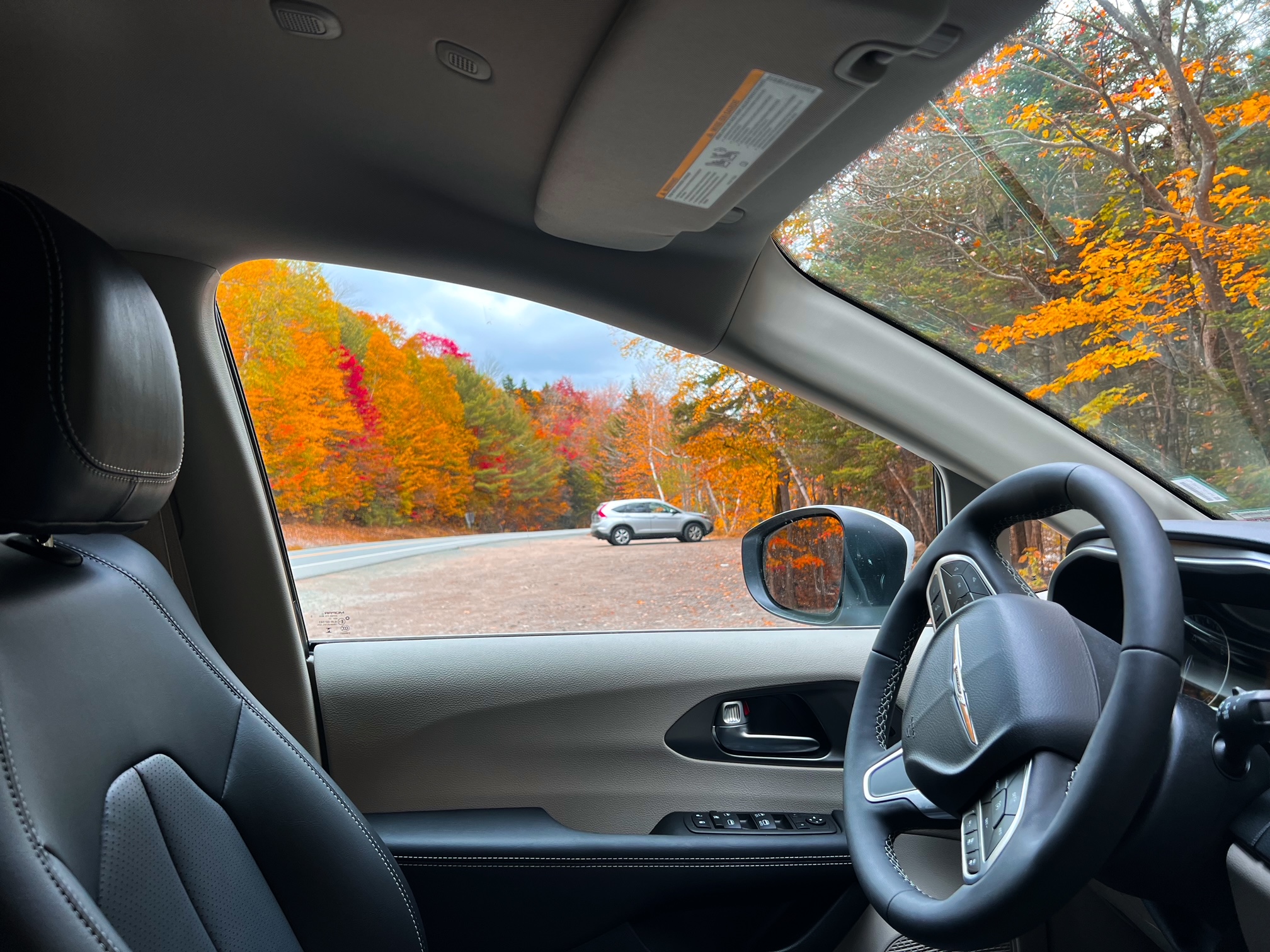 No New England Fall Foliage Road Trip Itinerary is complete without knowing the ins and outs of the drives that will take you to look outs and down roads that you can look out windows and witness the fall colors at, as seen in this photo. 