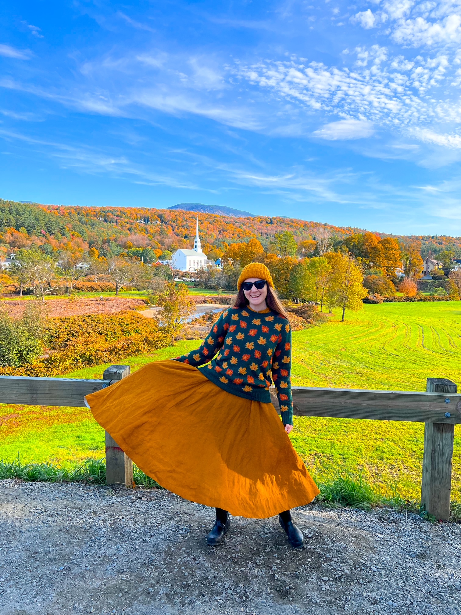 The Stowe Church Viewpoint offers great photos of a stunning chapel and the area of trees: a women flares her orange skirt in this photo, and it matches the trees behind her that circle the white church of Stowe! 