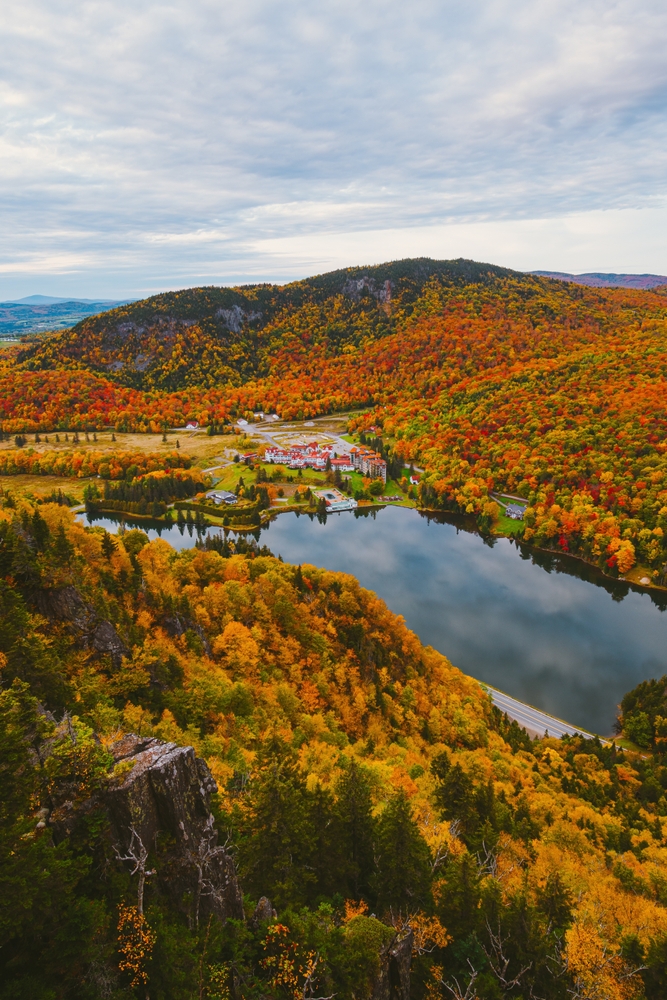 The view of Table Rock Trial shows a high access point that overlooks buildings, trees and mountains, and is a must for your New England Fall Foliage Road Trip Itinerary. 