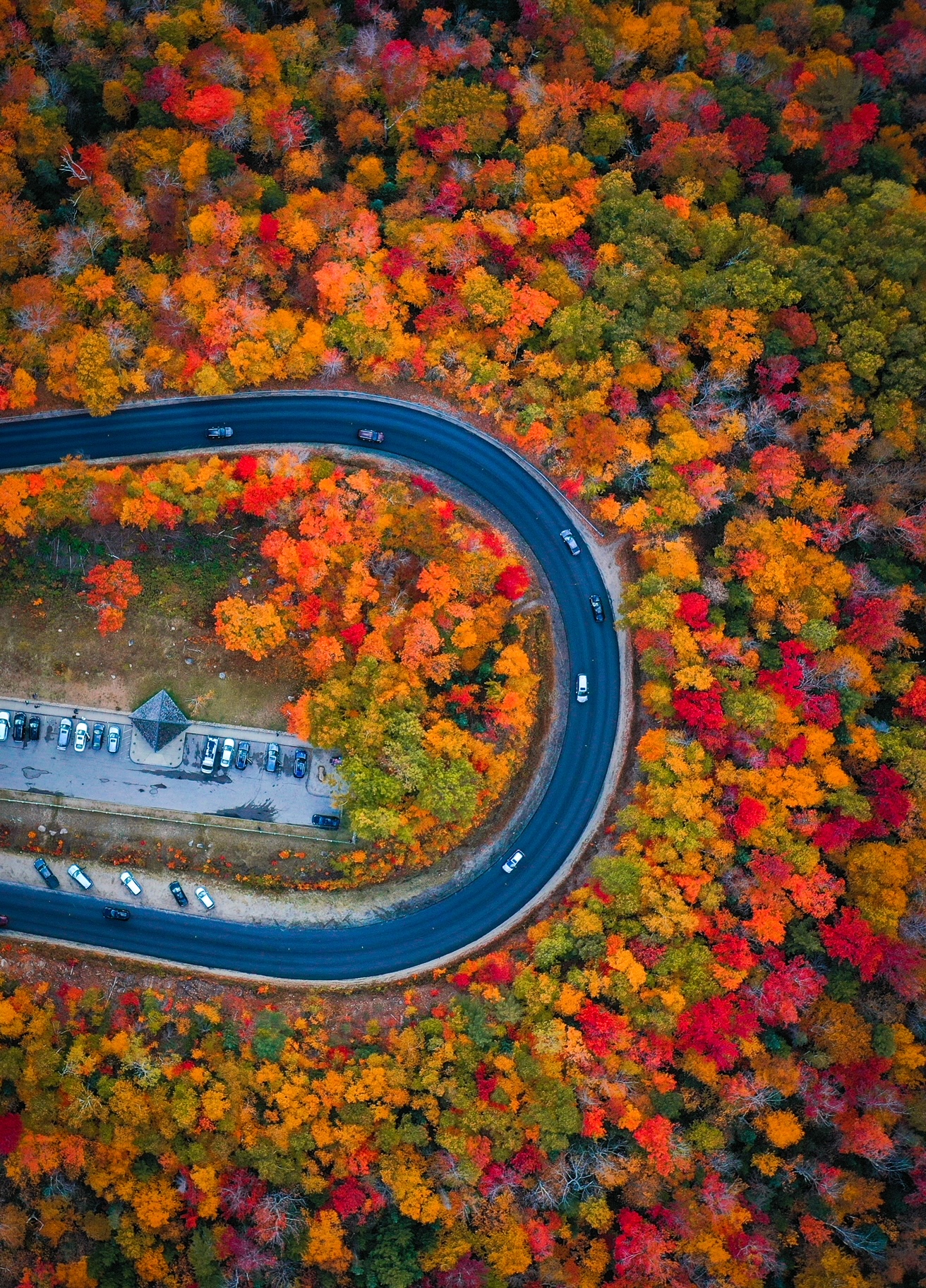 This drone shot shows the drive of Kanacamagus Highway: the loop of the road is surrounded by tons of fall colors and is a must see for your New England Fall Foliage Road Trip Itinerary. 