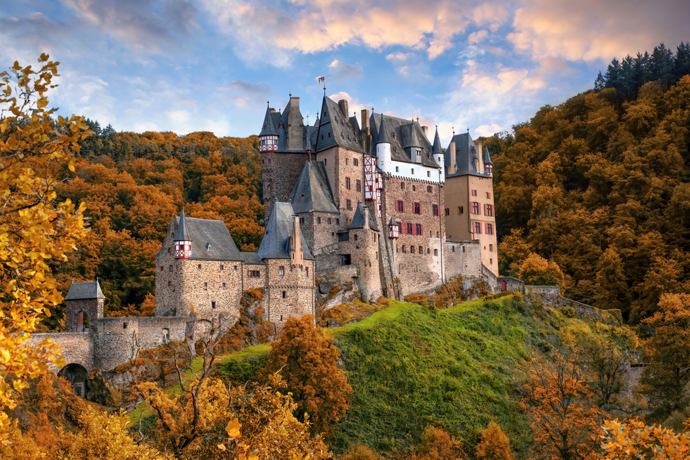 Amazing panoramic view of Burg Eltz castle at autumn evening. Picturesque burning sky. Burg Eltz is a popular travel destination in Rhineland-Palatinate, Germany