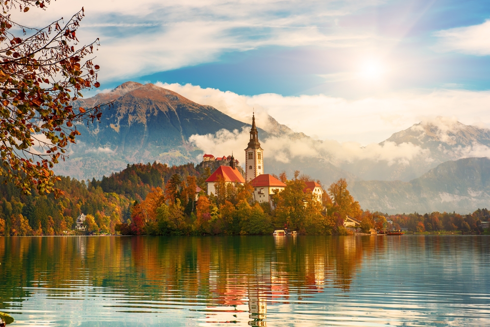 Church of Assumption in Lake Bled, Slovenia with blue sky and clouds in the autumn