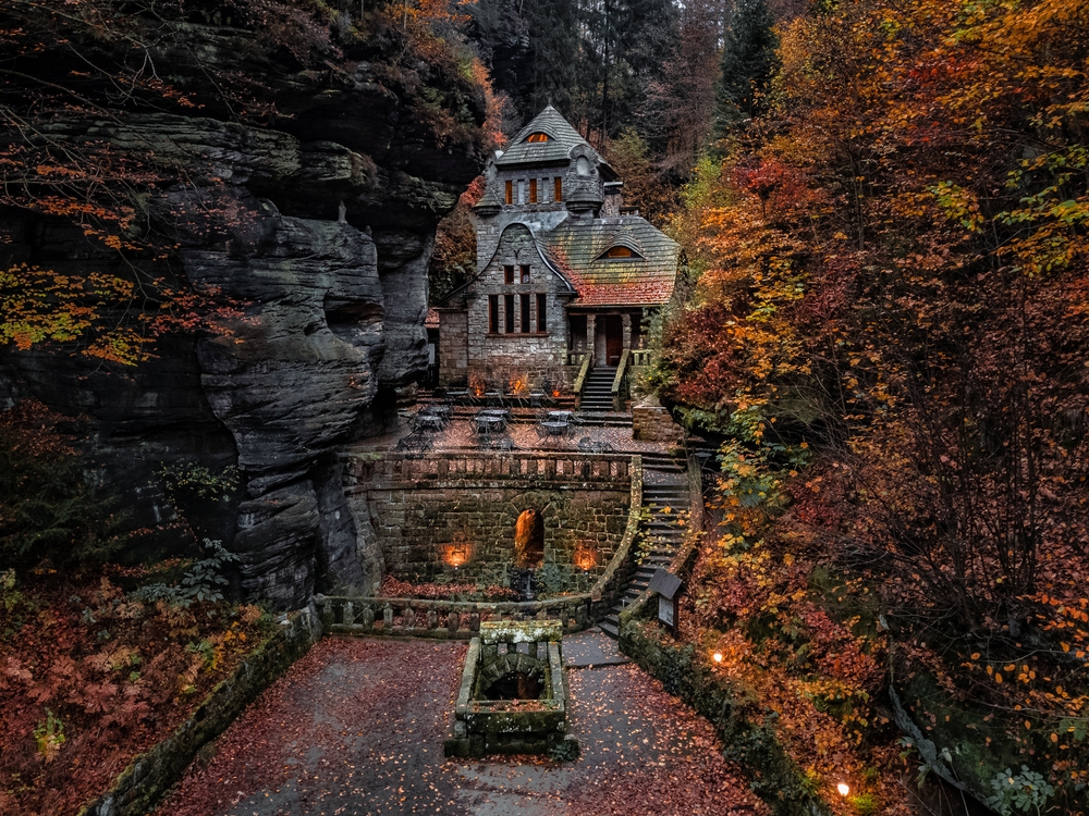 Hrensko, Czech Republic - Aerial view of a lovely stone cottage in the Czech wilderness near Hresko at autumn with beautiful colorful fall foliage