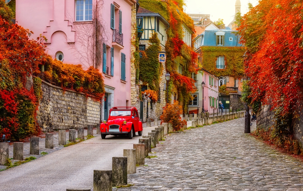 Cozy street in quarter Montmartre in Paris, France. Architecture and landmarks of Paris. Postcard of Paris