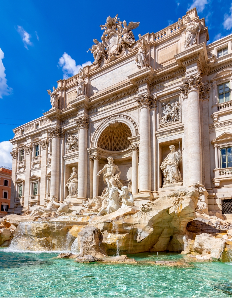 the trevi fountain, columns in background, water in foregound-one of the best things to do in Europe