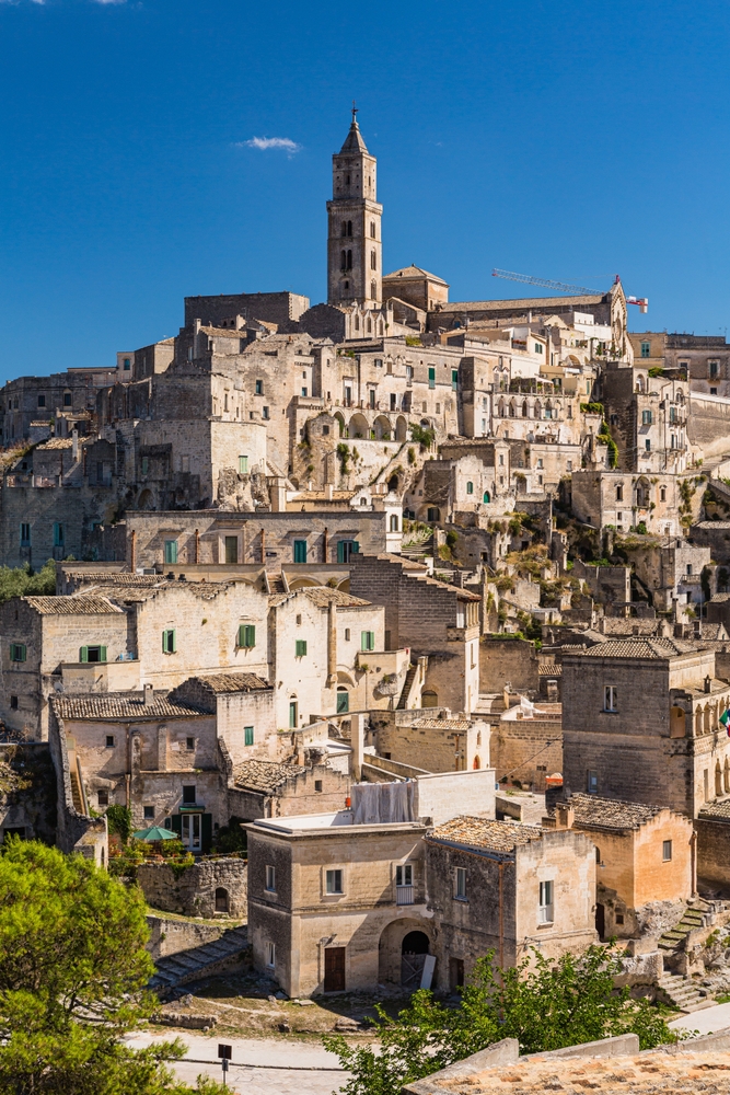 a terraced town of super old buildings with a tower on top, the town is the third oldest town in the world, photo taken on a clear day 