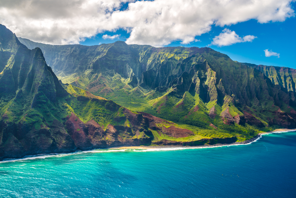 View on Napali Coast on Kauai island on Hawaii. You can see dramatic mountains that are full of vegetation. 