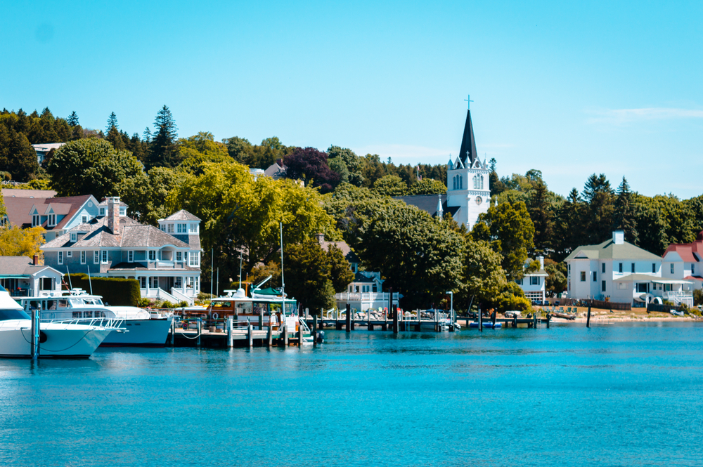 The Harbor at Mackinac Island. You can see the shoreline with houses and a church.  One of the  Islands USA citizens can visit without a passport. 