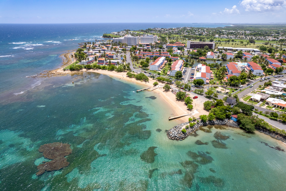 Aerial drone shot of Dorado Beach in the north of Puerto Rico. you can see the beach and buildings and sea. 