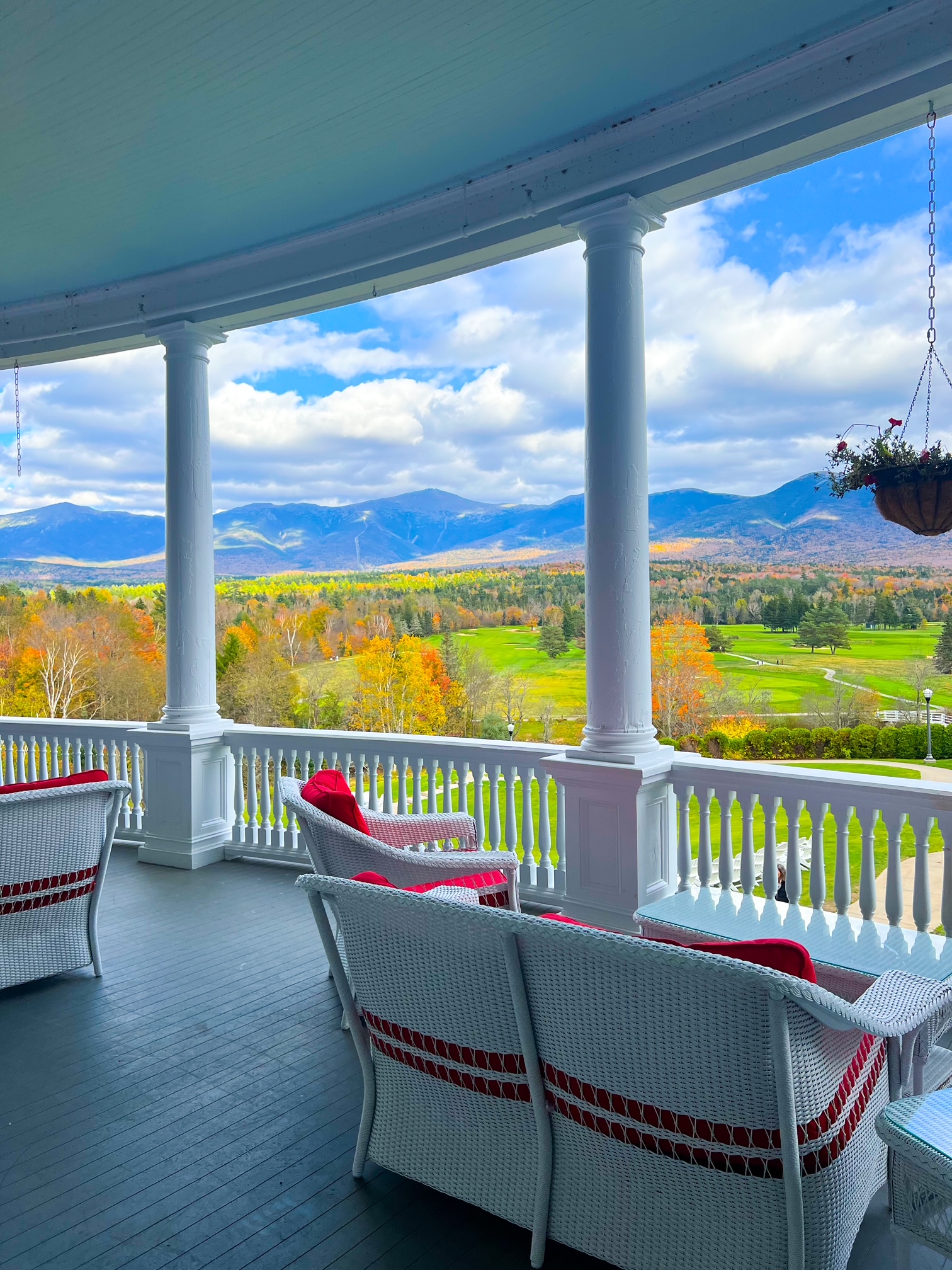 The Omni Mount Washington Resort offers stunning views of New Hampshire: You can see the mountains, the blue skies, the clouds, and the landscape of the green grounds coupled with the fall foliage trees from the back porch of this hotel. 
