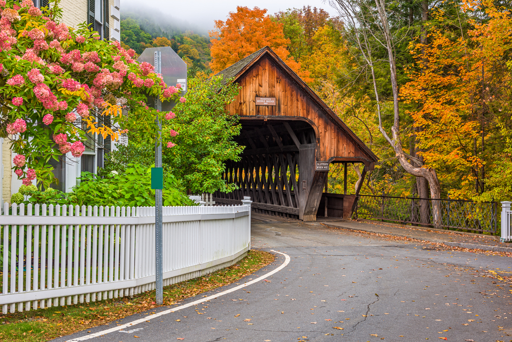 This dark oak, covered bridge is surrounded by fall foliage in New England and is a part of the true spirit of historic, fall charm! 