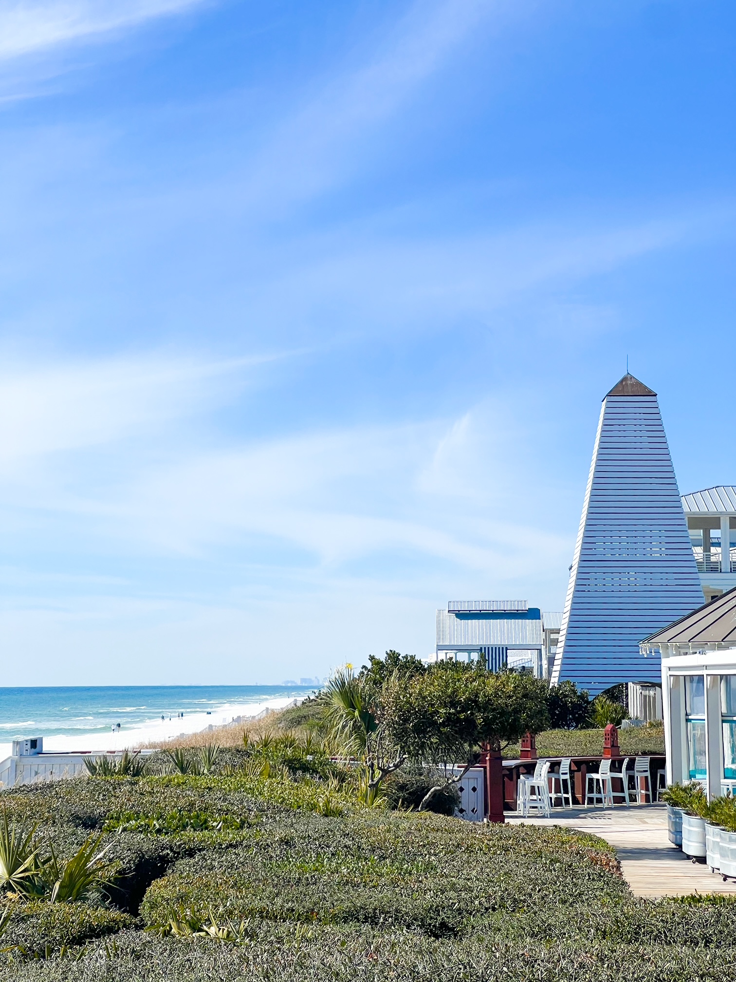 a view of the beach in seaside with its iconic tower in the background