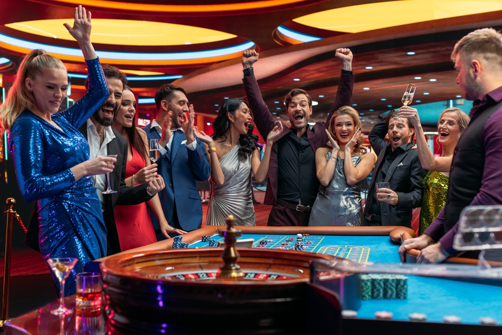 Friends gambling around a black jack table in Las Vegas, the most well known 30th birthday destination!