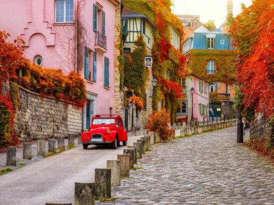 november foliage in paris with pink building and red car