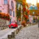 november foliage in paris with pink building and red car