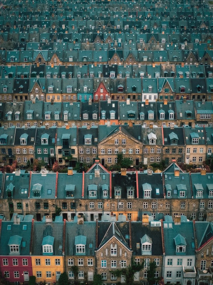 aerial photos of homes next to each other in copenhagen denmark, there are many rows filling the whole photo 