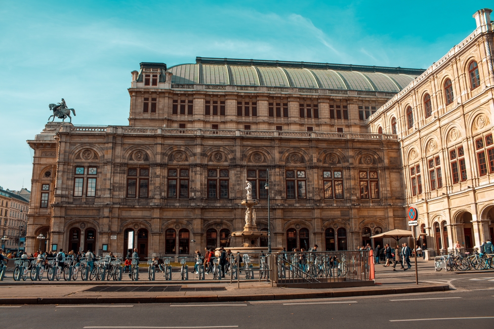 tall building in Vienna with an arched tin roof and bike parking out front