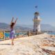 woman standing on a European fort with blue water in the back