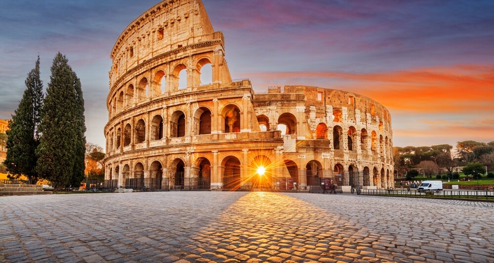 the Colosseum with the sun streaming through one of the front arches