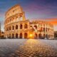 the Colosseum with the sun streaming through one of the front arches