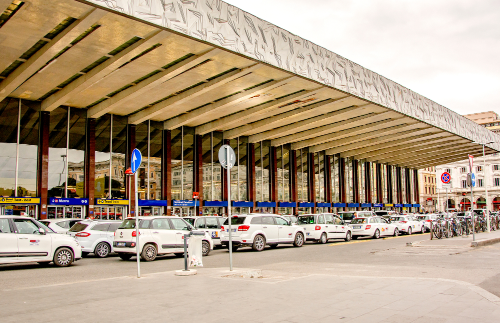 a line of white taxis waiting for their next customers