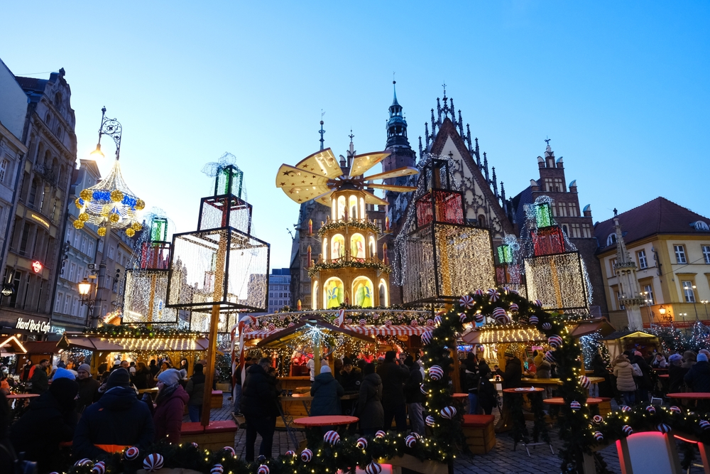 A Christmas market in Wroclaw shows how popular and bright this city can be: lights designed and shaped like presents line the town hall streets, along with wreaths, as people walk through a market and shop. 