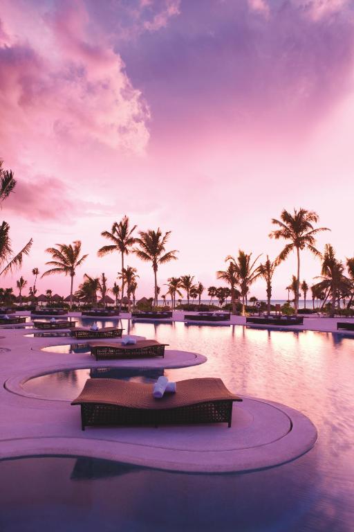 A swimming pool at sunset in an article about adults-only all inclusive resorts in the Caribbean. 