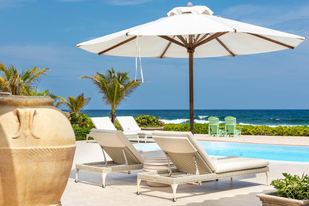 the pool and lounge chairs overlooking the ocean at Le Soleil D'or one of the hotels on Cayman Brac 