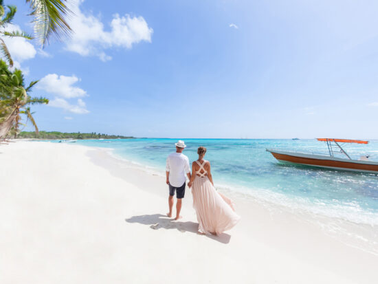 woman and man standing on a beach in the Caribbean on their honeymoon