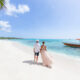 woman and man standing on a beach in the Caribbean on their honeymoon