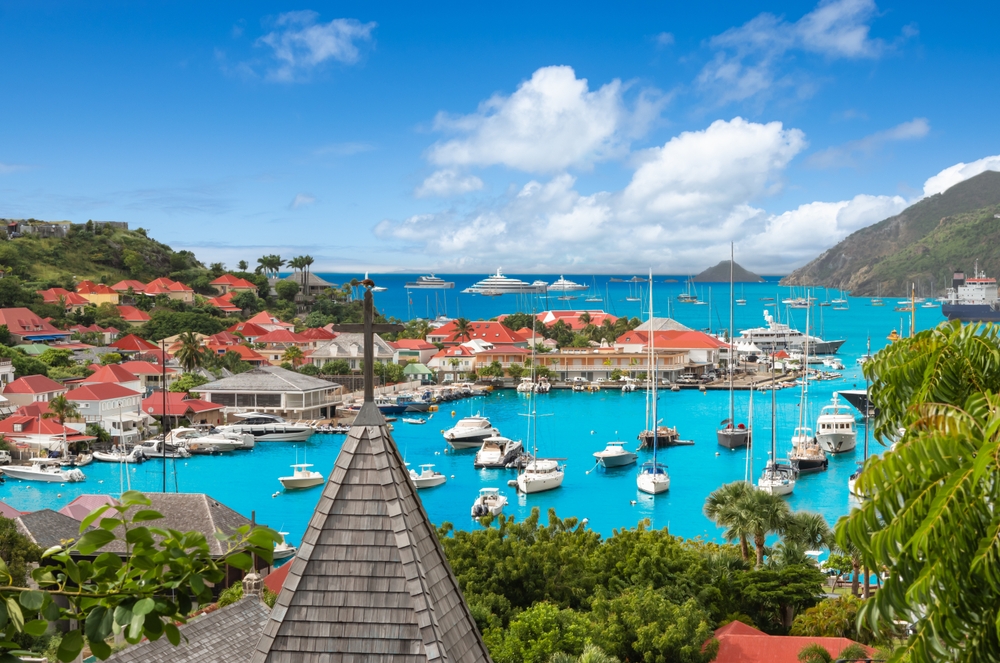 The harbor in st Barts with its turquoise waters, boats and terracotta tiled roofs