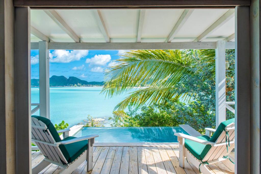 view of the deck and pool over the ocean in one of the rooms at an adults-only all inclusive resorts in the Caribbean