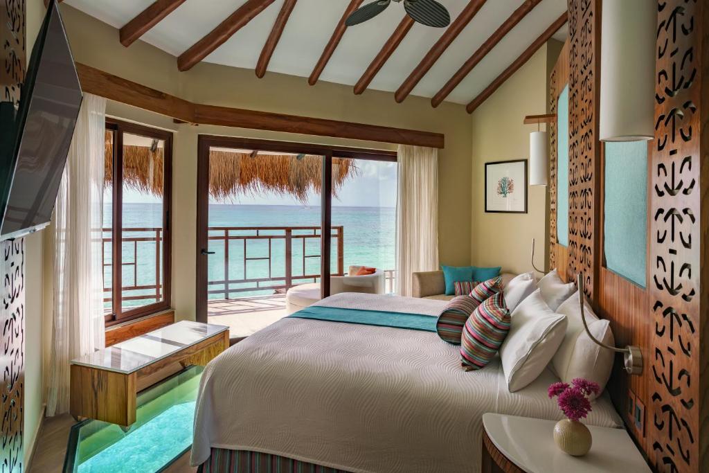 inside one of the overwater bungalows at one of the adults-only all inclusive resorts in the Caribbean