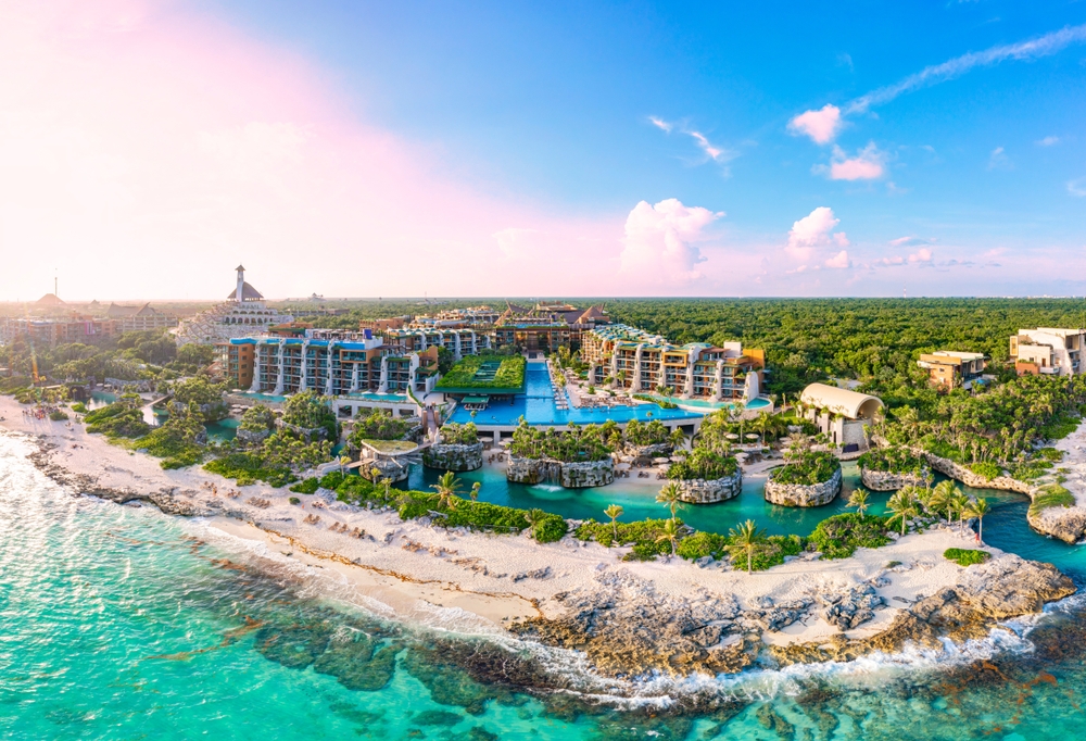 When considering all inclusives vs cruises, take a look at what both have to offer: this photo shows a Caribbean resort with aqua waters, private beaches and blue pools. 