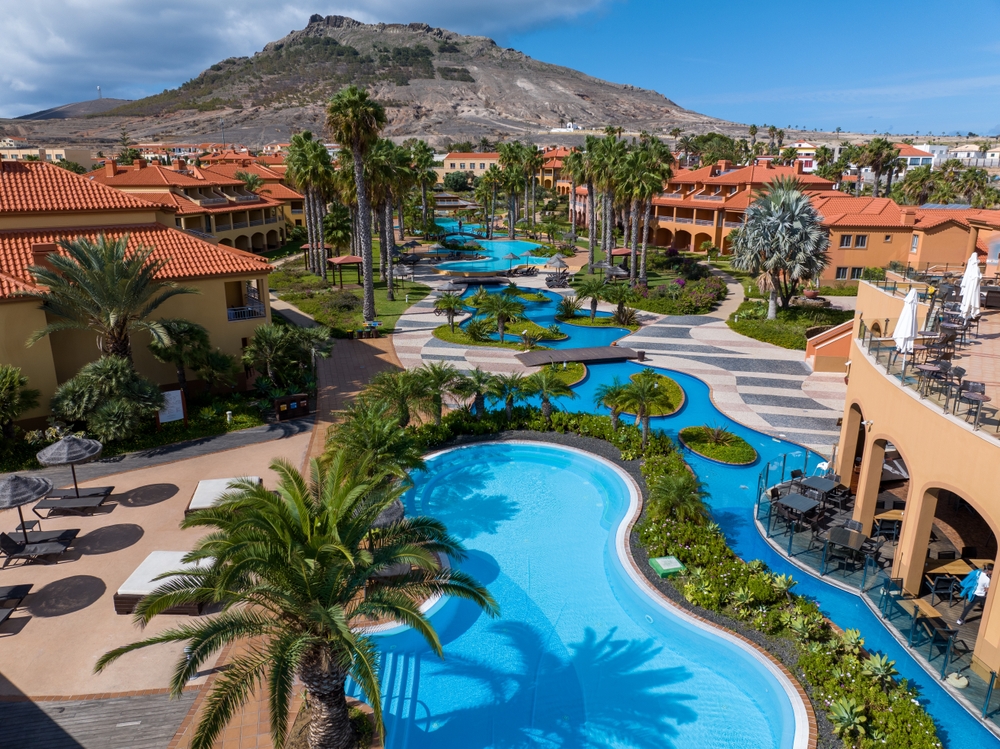 A side shot of an all inclusive resort shows the differences of  all inclusives vs cruises: this resort has everything you need in one space: restaurants, pools, shops, walkways, balconies, and even suites! 