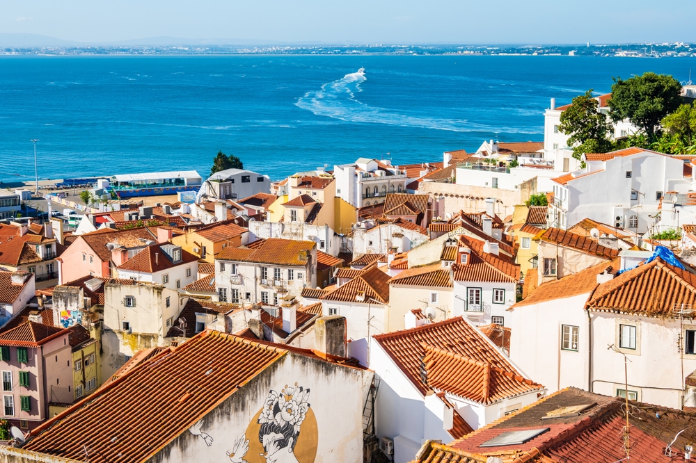 one of the best places to visit in europe in January, ocean in the background and man houses in the foreground on a clear day