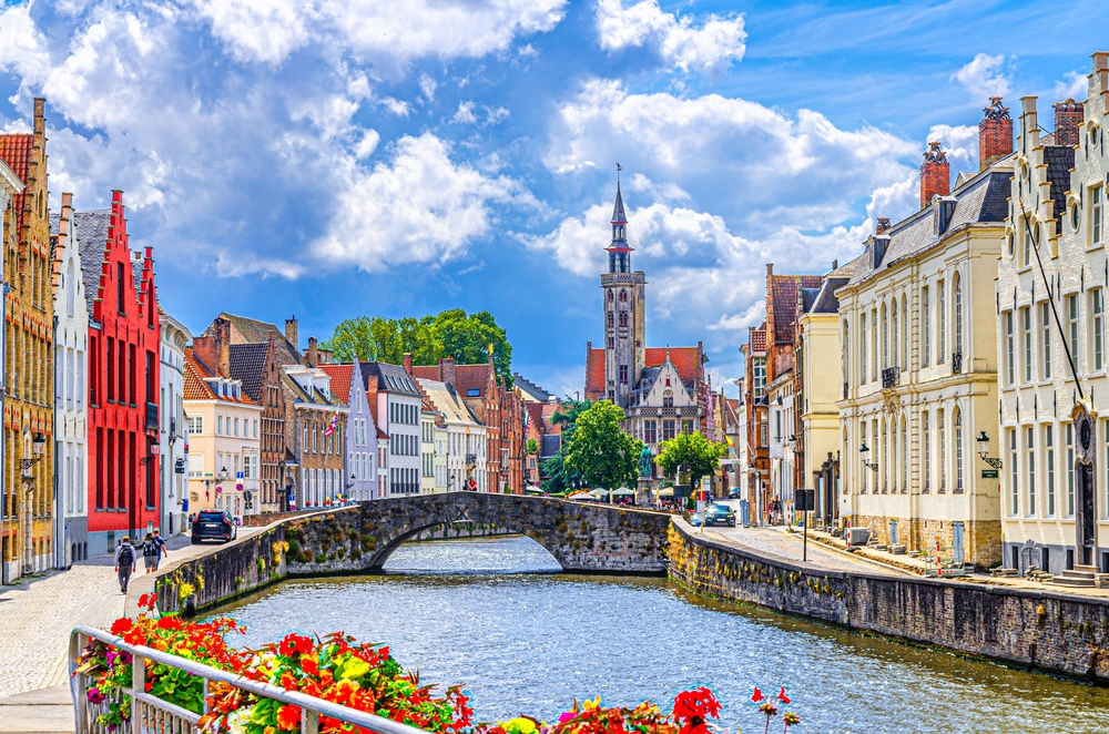 Blue hour sunrise landscape with water reflection houses on Spiegelrei Canal Bruges.