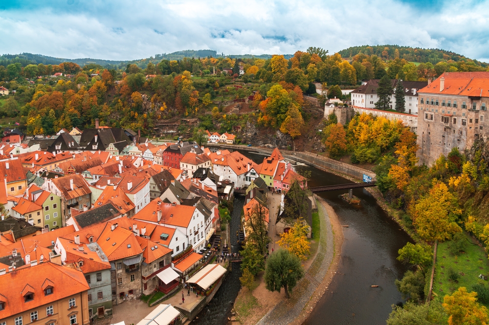 The town of Český Krumlov from above during fall. You can see the town and the river.  