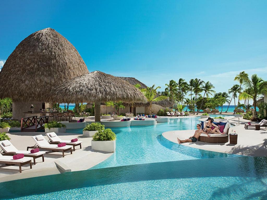 Couple by the pool in one of the adults-only all inclusive resorts in the Caribbean