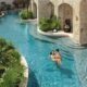 couples lounging in the pool at a luxury all inclusive resort